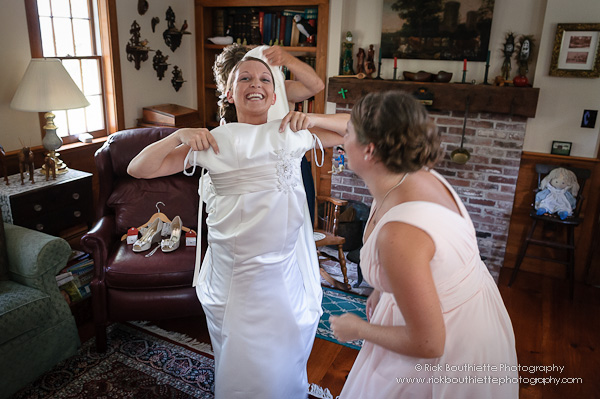 Bride putting wedding dress on.