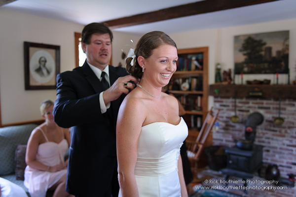 Father of the bride helps with necklace