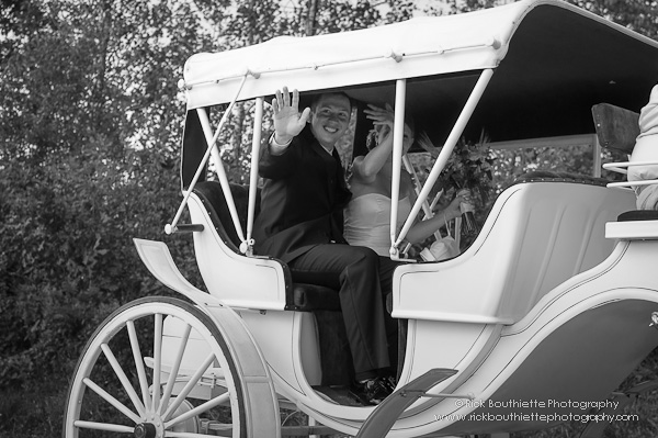 Bride & Groom wave as the leave wedding ceremony, carriage