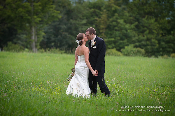 Bride & Groom in hay field kissing