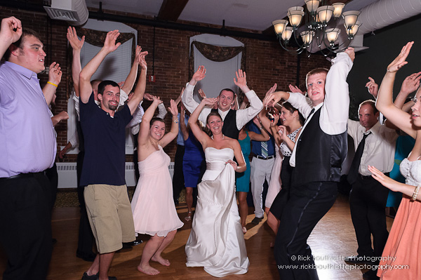 Bride & groom dancing in crowd at wedding reception, Fratello's, Manchester