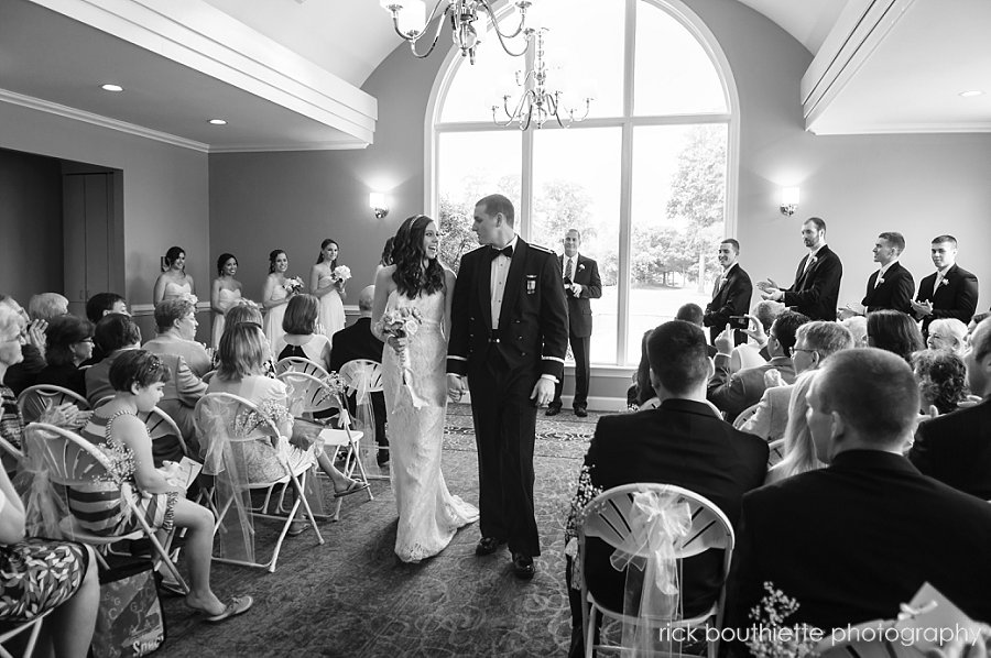 Bride and groom walk down aisle