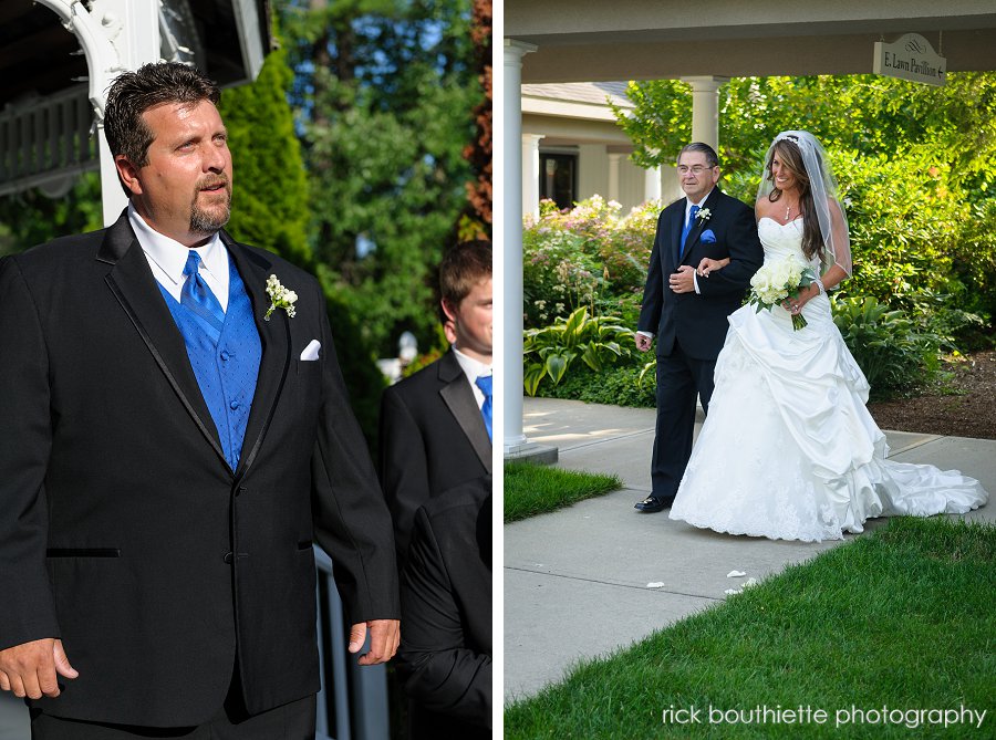 Groom sees bride as she starts down aisle at the executive court banquet facility