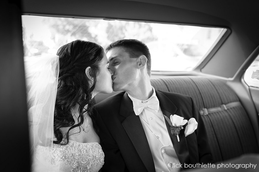 bride and groom kissing after wedding ceremony, Manchester, NH