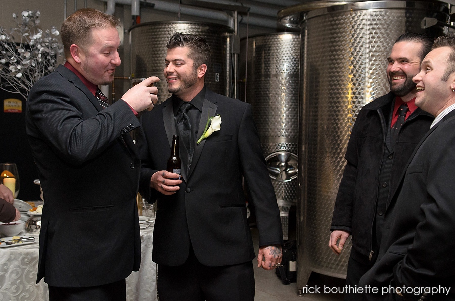 Groom and groomsmen at wedding cocktail hour in the Wine Cellar