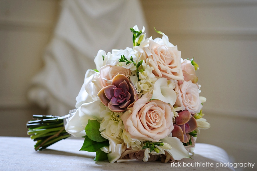 Bride's bouquet with dress in background