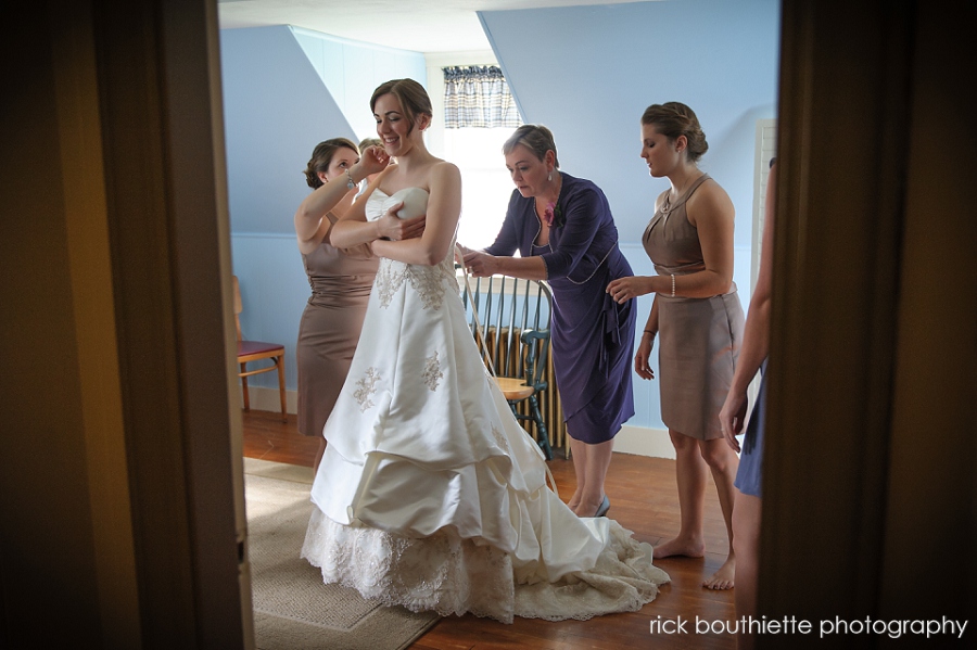 bride with bridesmaids and Mother getting ready for wedding