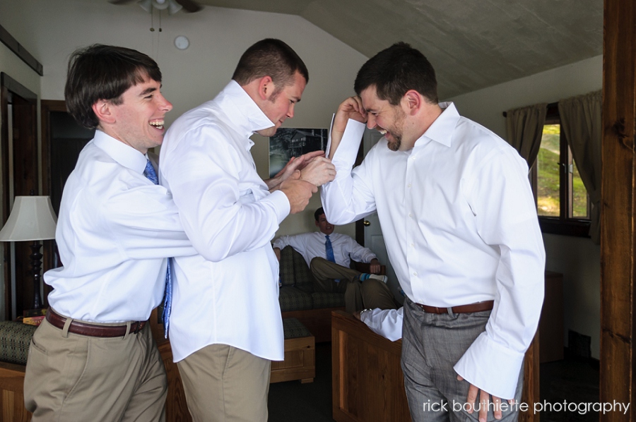 groomsmen helping groom with cufflinks