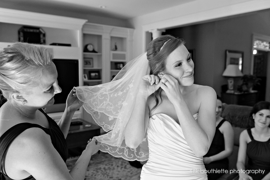 bride putting earring on