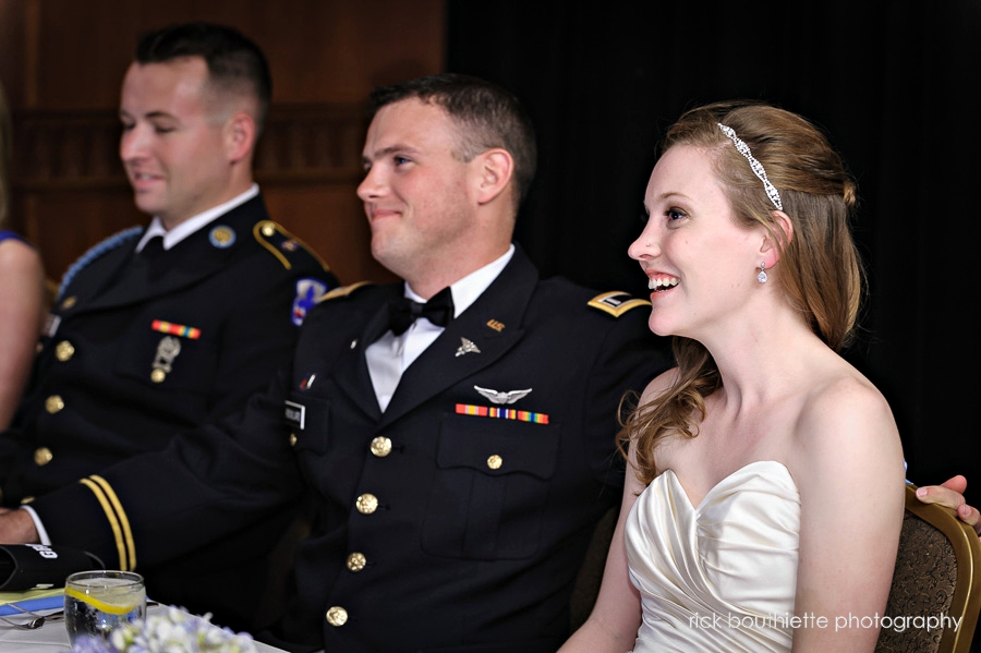 bride and groom laughing during toast at wedding reception