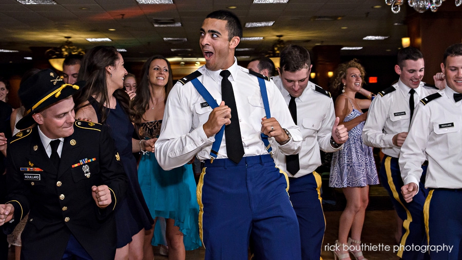 groomsman in uniform dancing at wedding reception