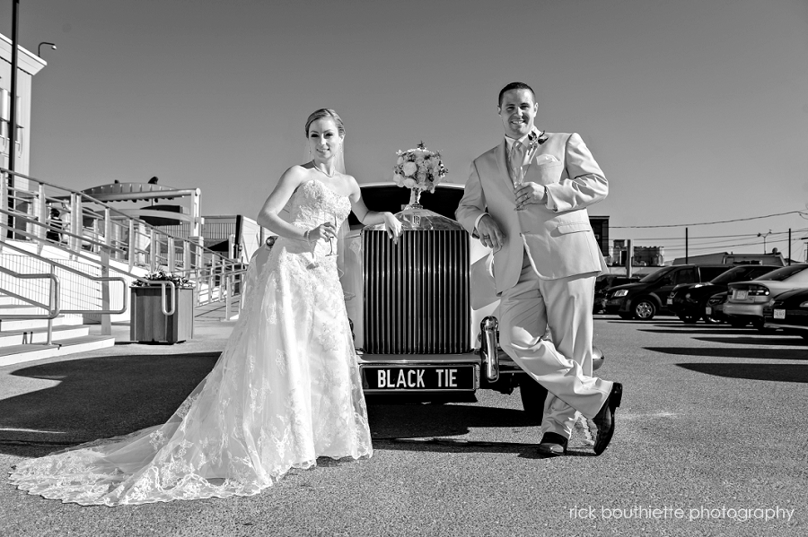 bride and groom with rolls royce at their blue ocean music hall wedding