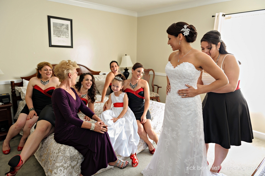 bride surrounded by her bridesmaids as she gets ready for her WACHUSETT VILLAGE INN WEDDING