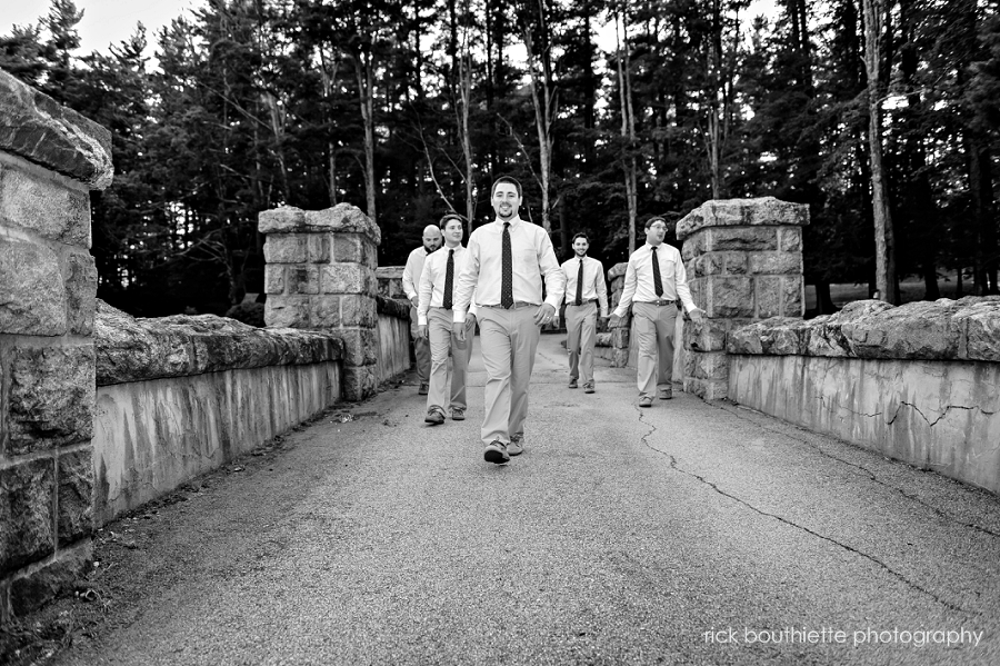 groomsmen walking across bridge