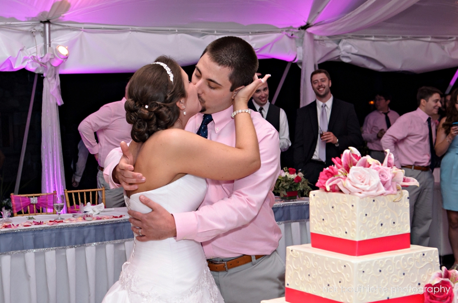 bride & groom kissing after cutting cake