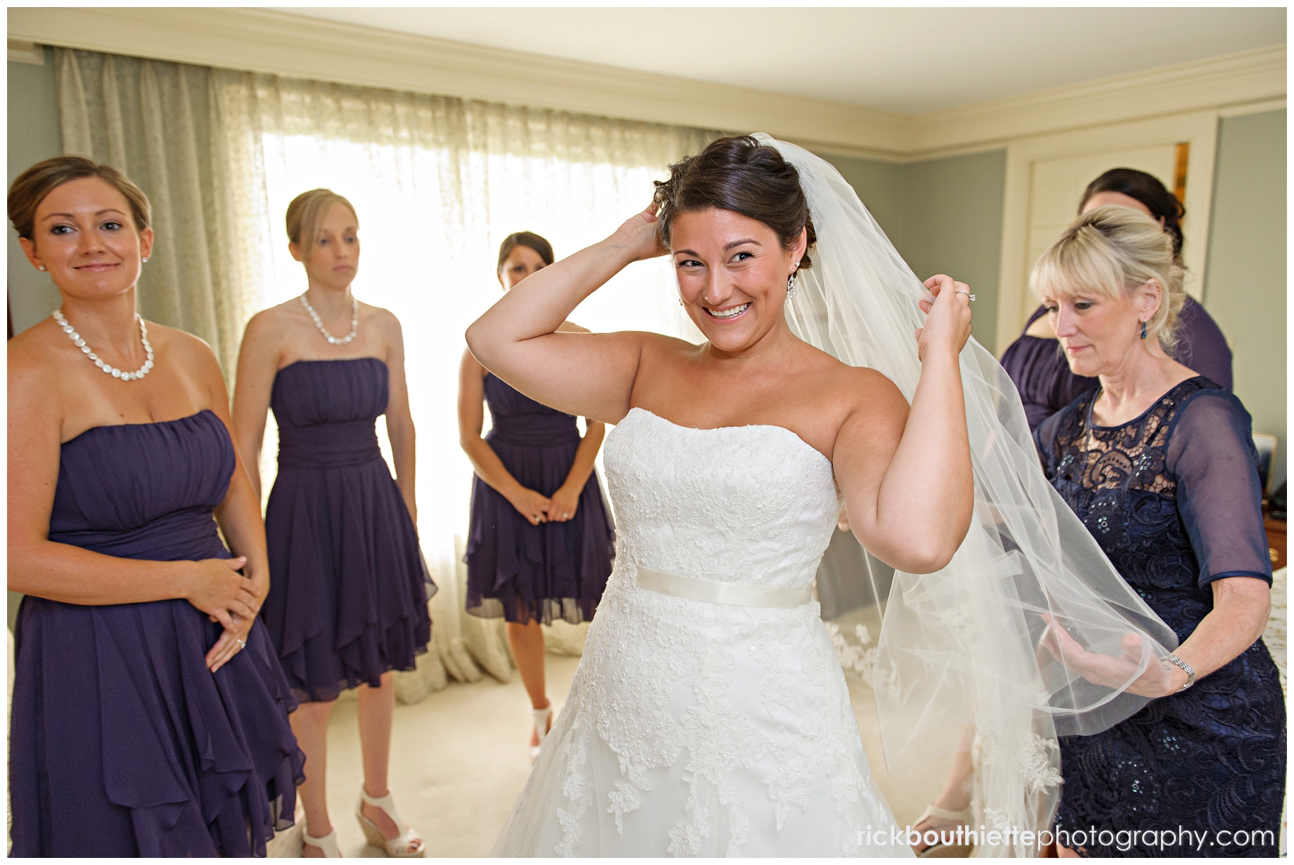 putting veil on bride