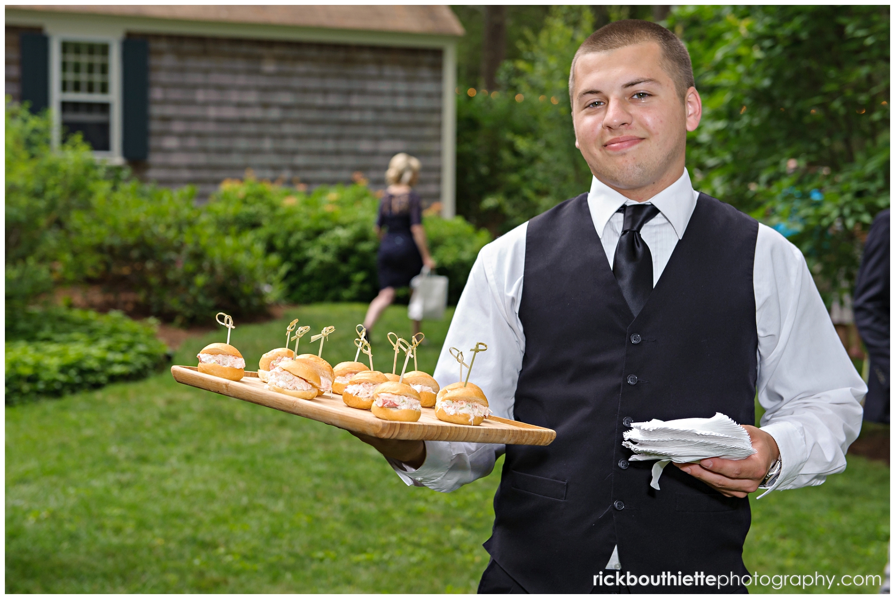 server with tray of food at outdoor wedding cocktail hour