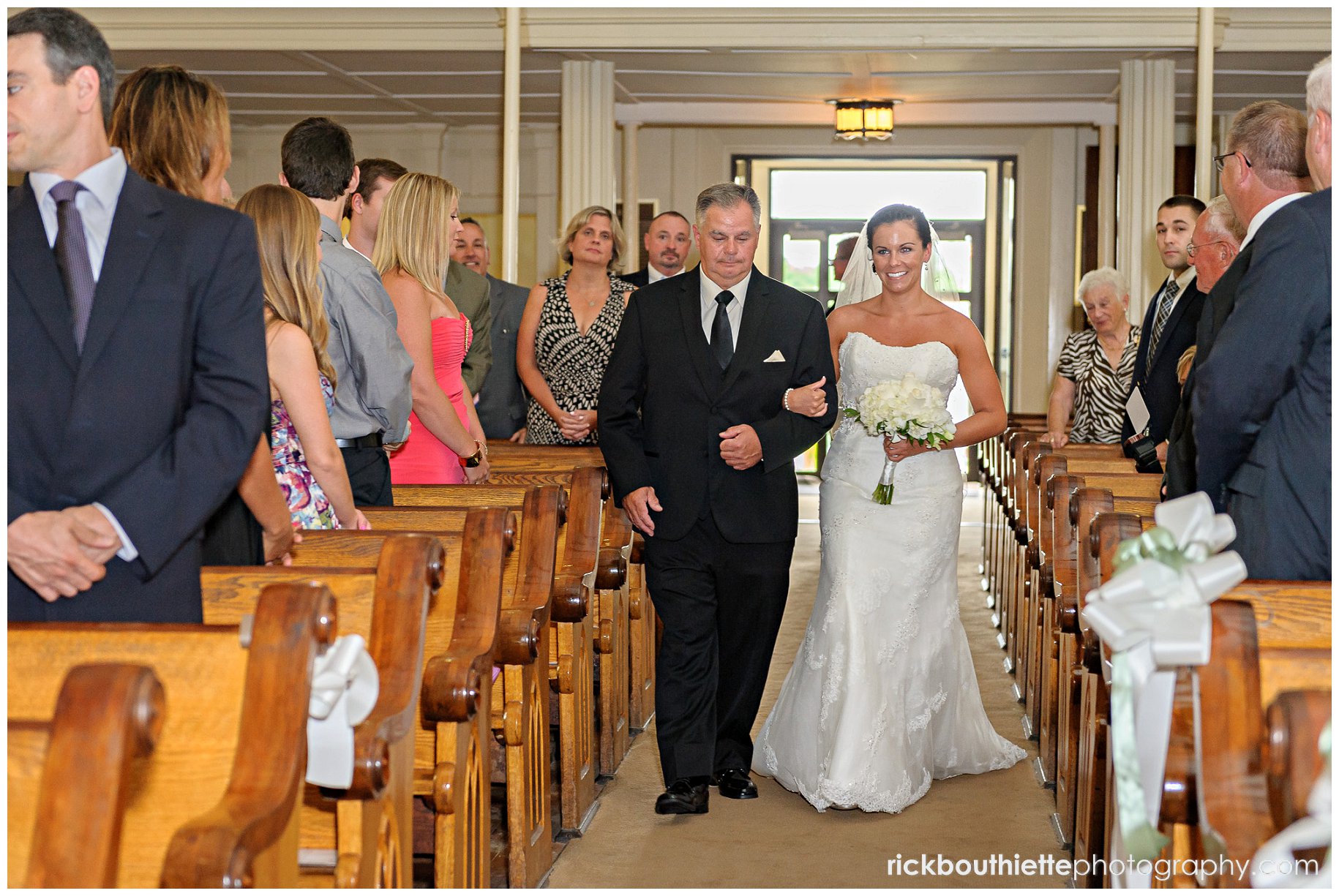 bride walking down aisle with her dad