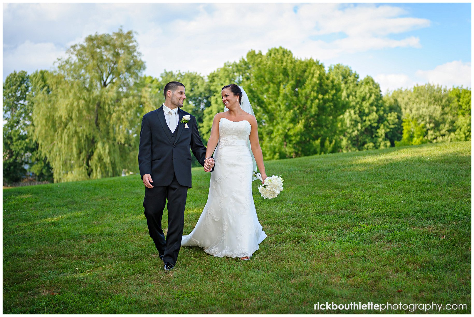 bride & groom holding hands and walking