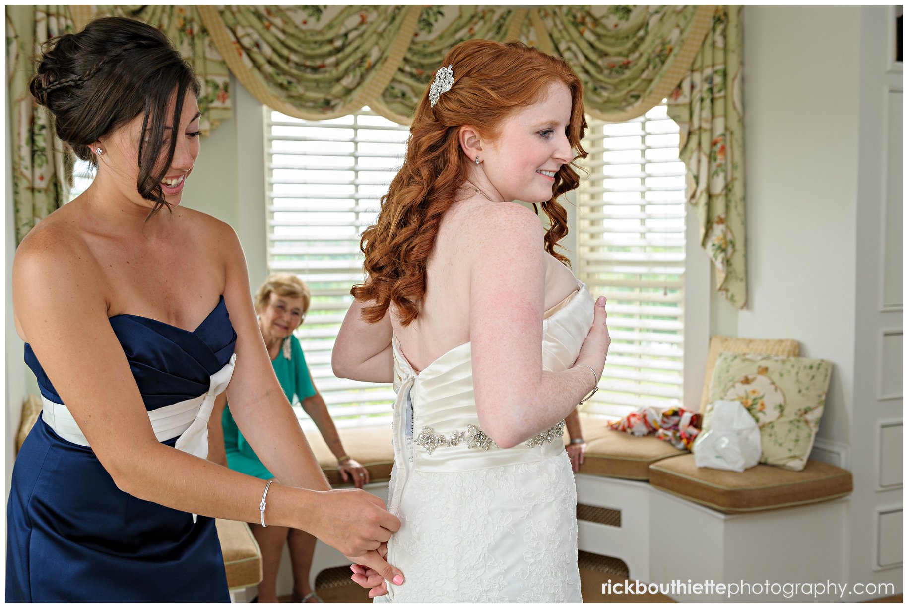 bride getting ready with maid of honor