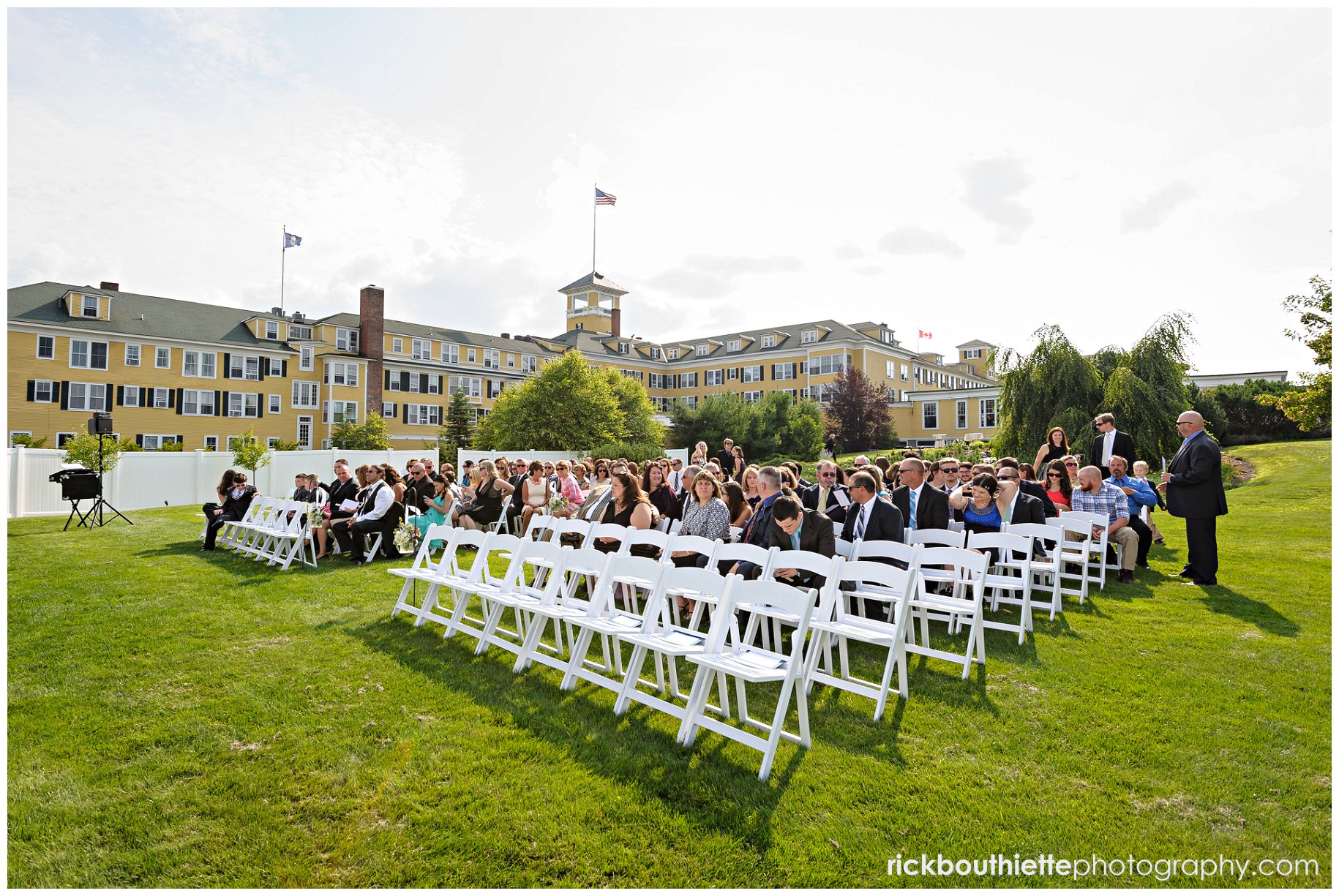 guest gather for wedding ceremony, Mountain View Grand hotel in background