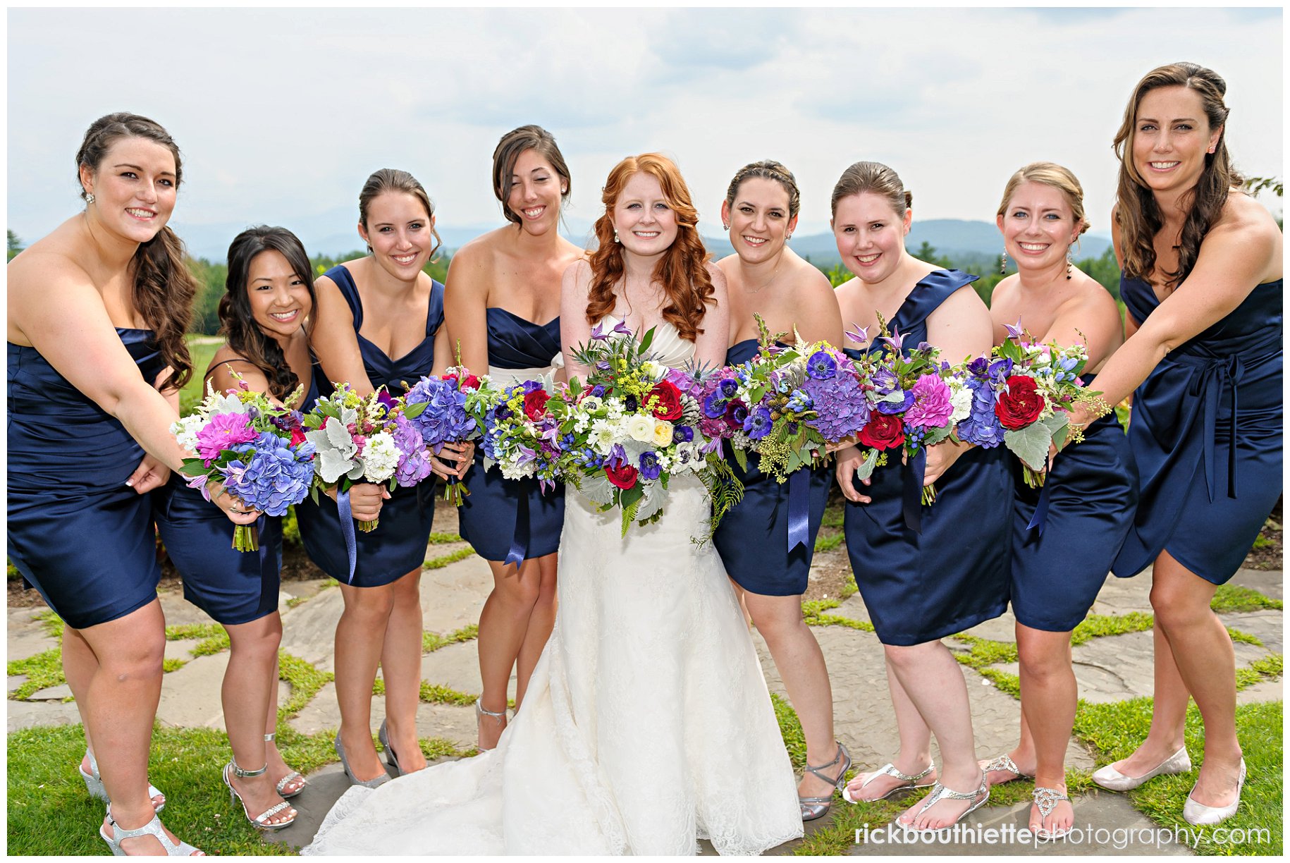 bride and her bridesmaids showing off their bouquets