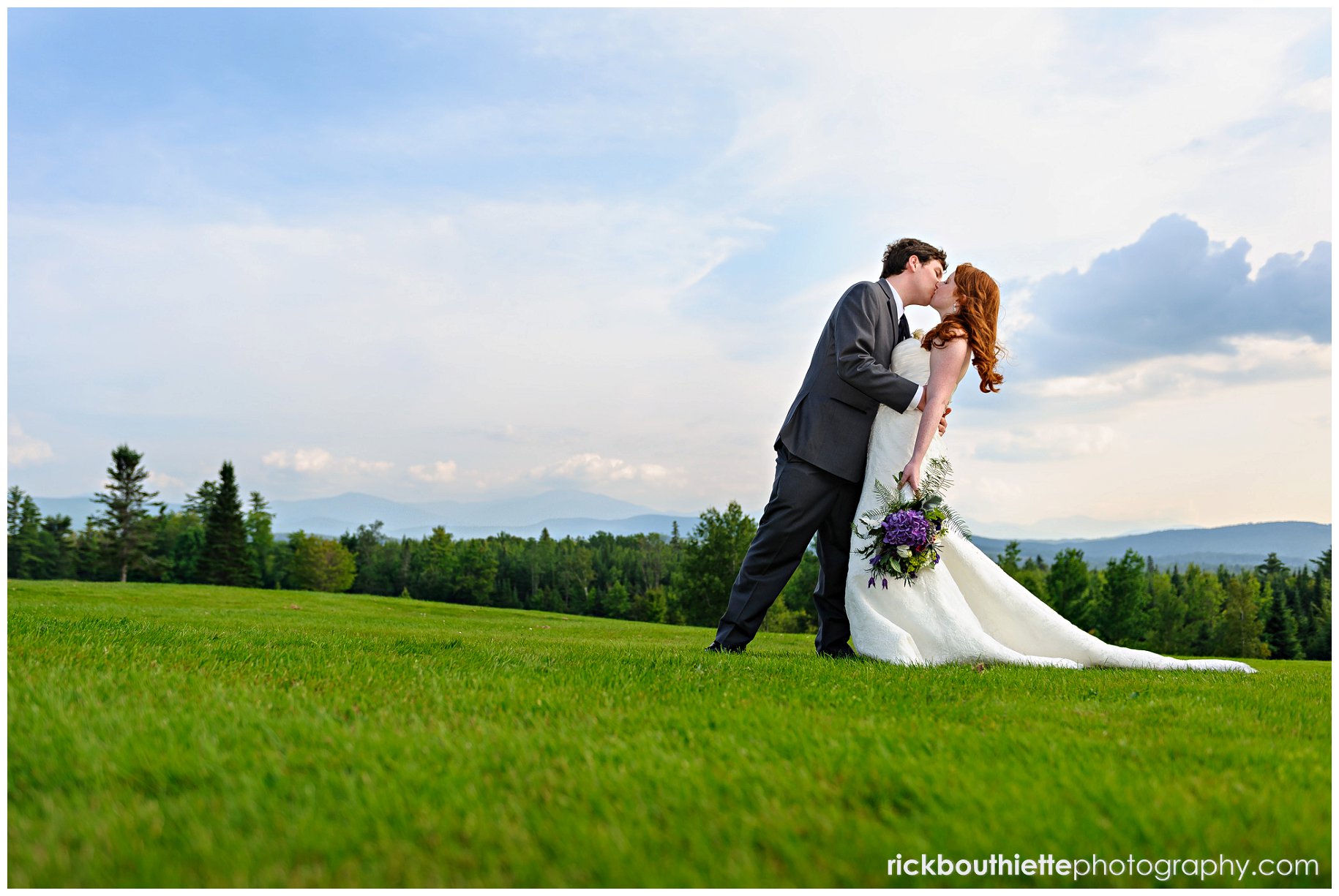 bride and groom kiss on the overlook lawn at Mountain View Grand