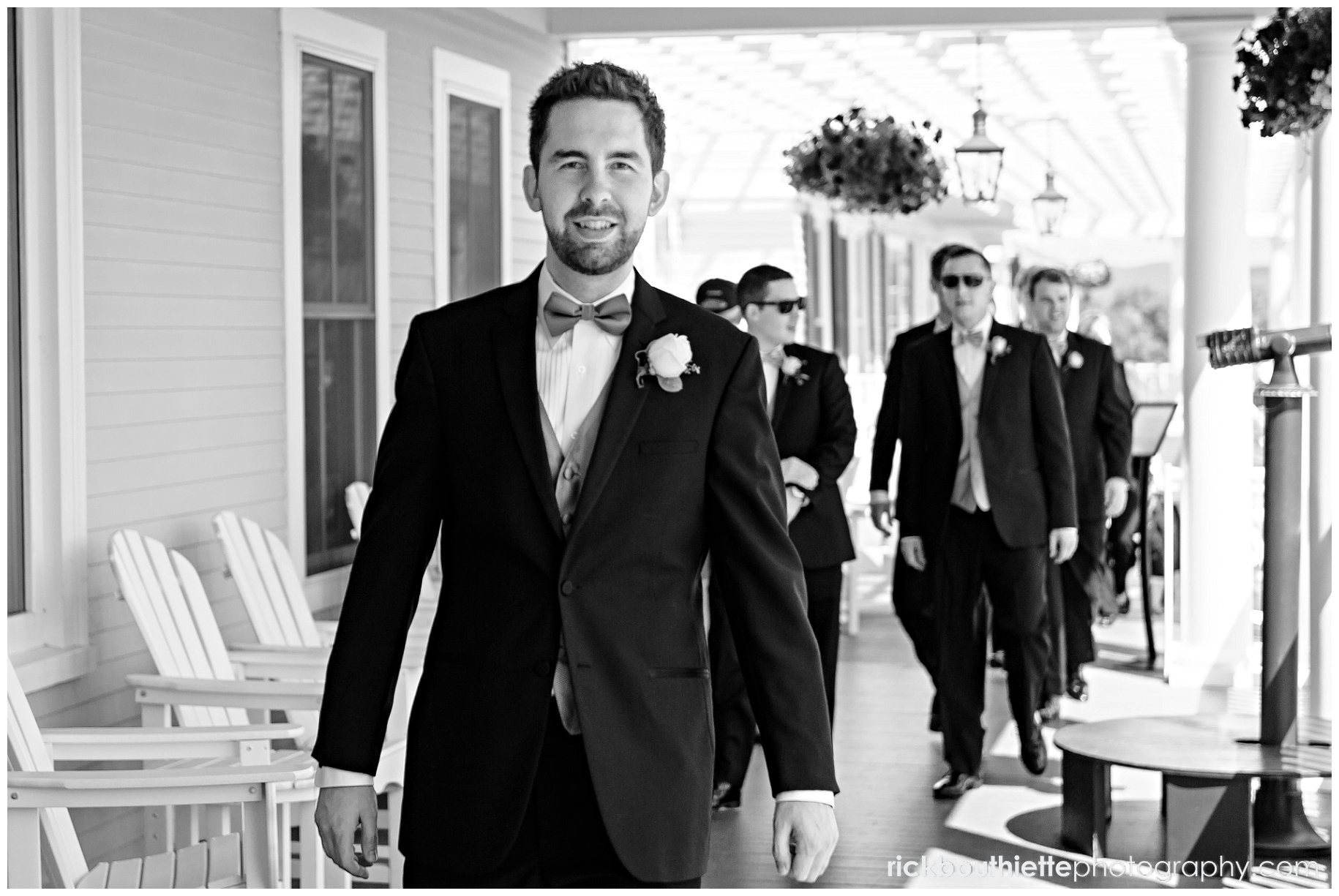 groom and groomsmen walking on veranda at Mountain View Grand