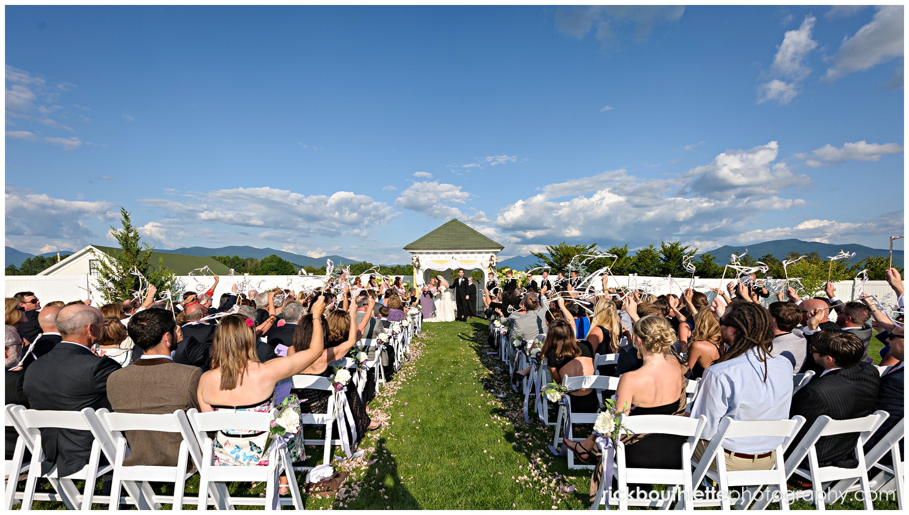 guests waving streamers after bride and groom's first kiss