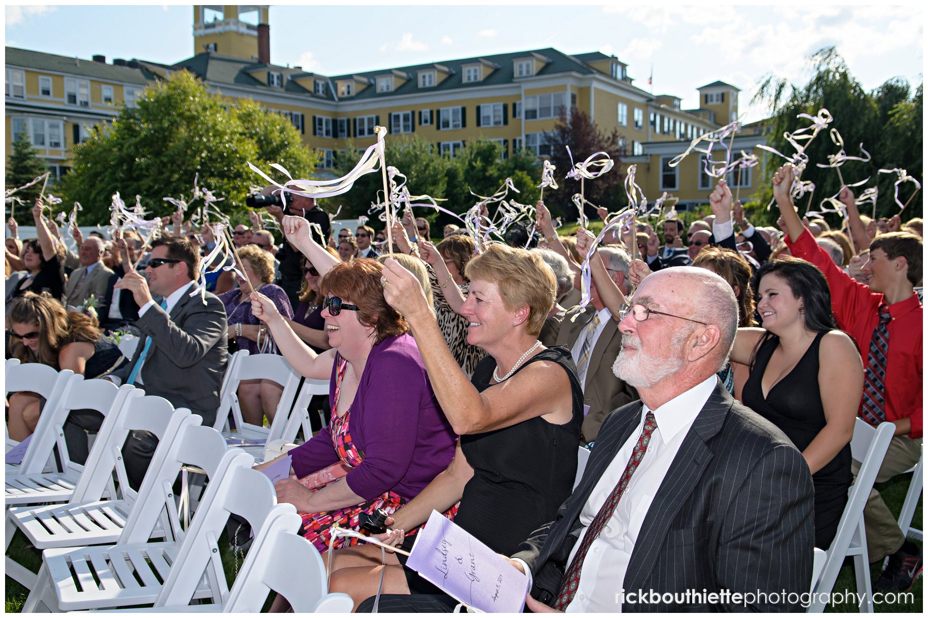 guests waving streamers after bride and groom's first kiss