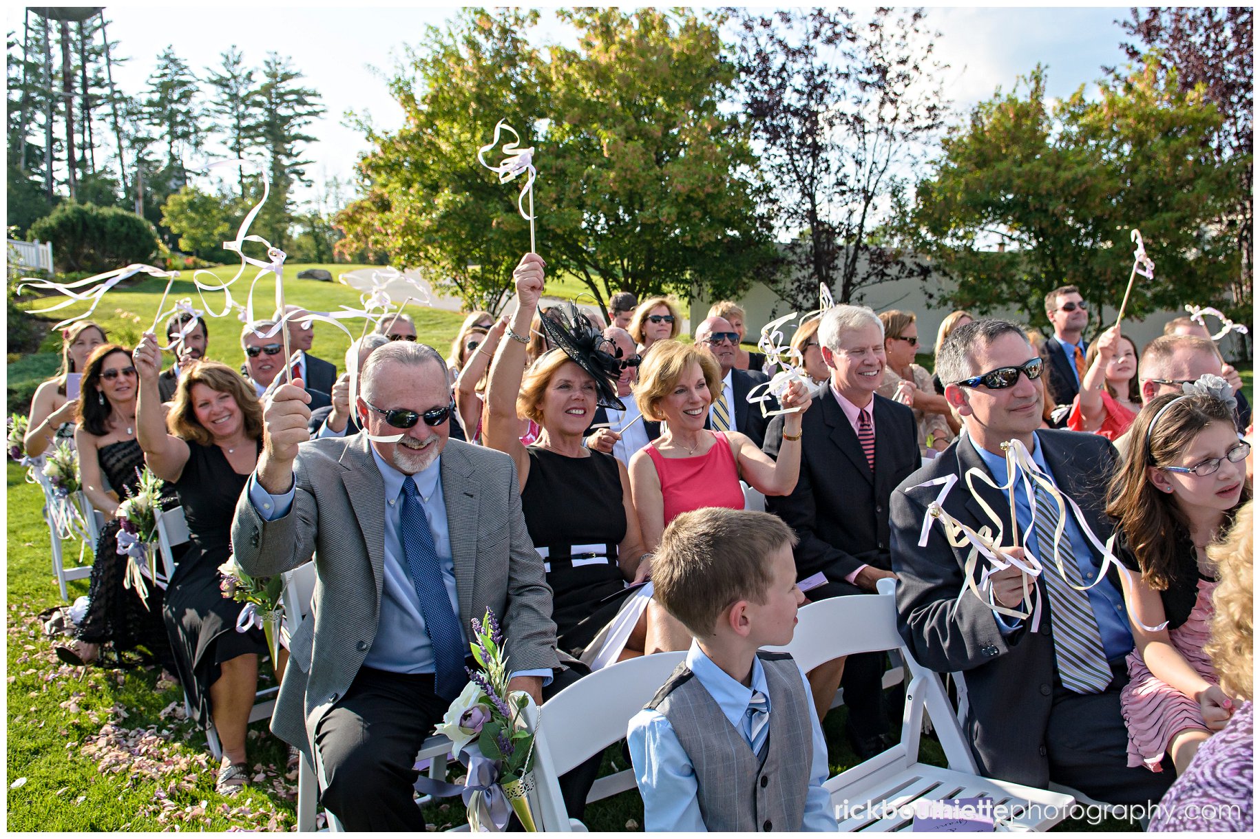 guests waving streamers after bride and groom's first kiss