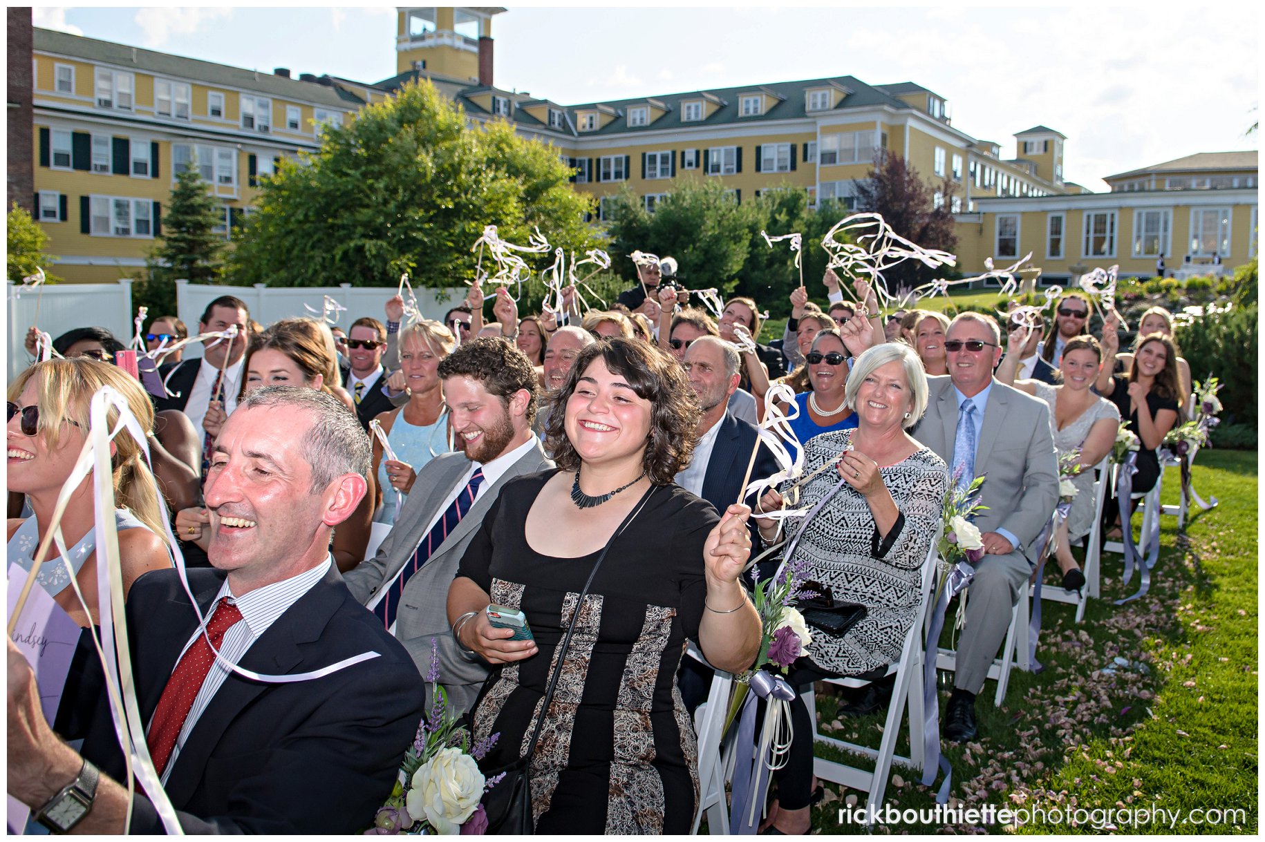 guests waving streamers after bride and groom's first kiss