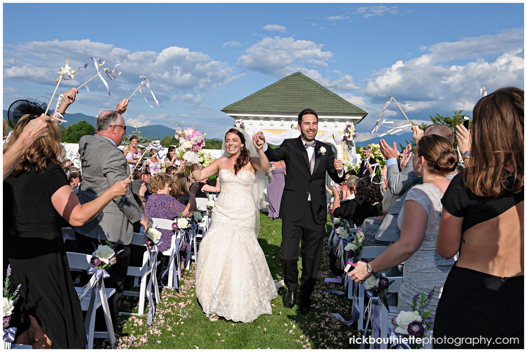 bride and groom celebrate as they walk down the aisle