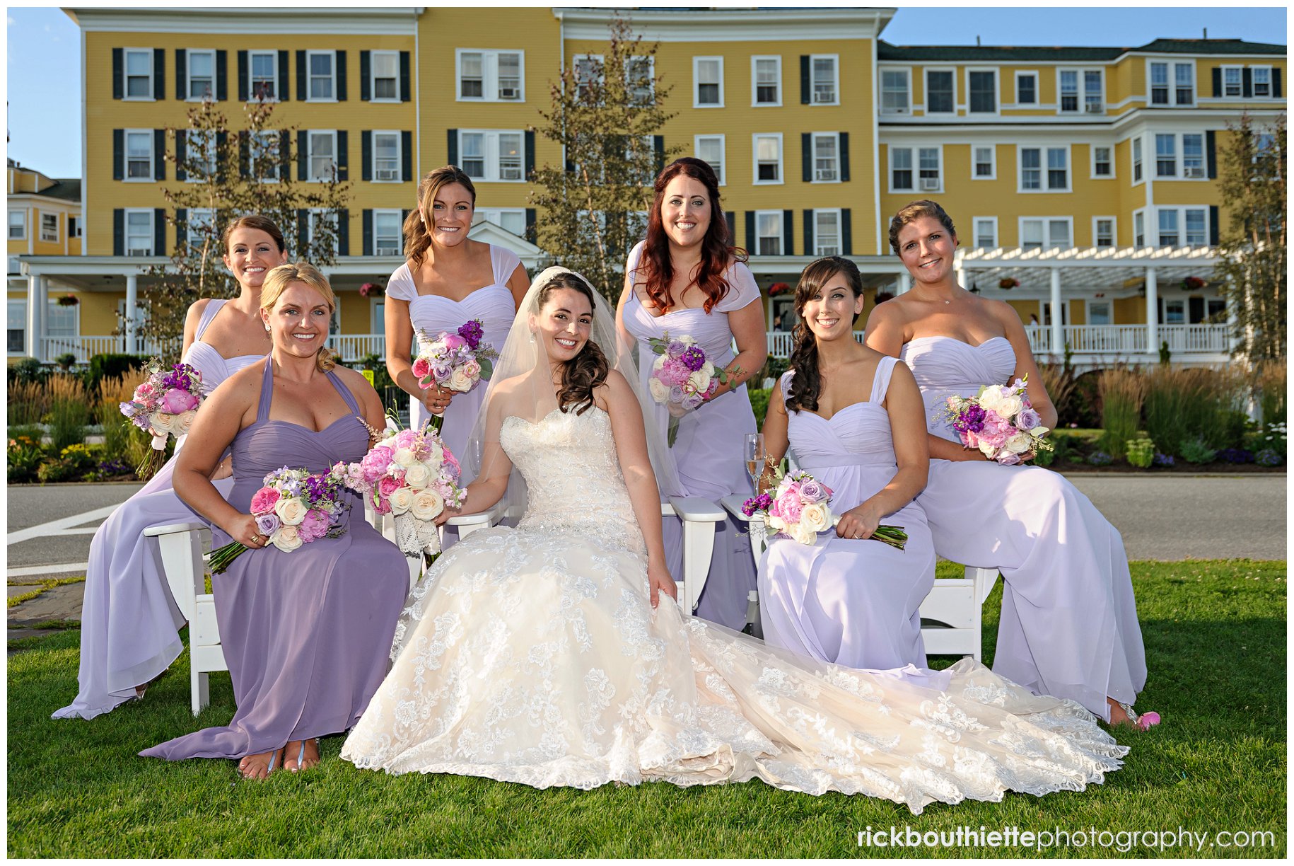 bride and her bridesmaids on Adirondack chairs in front of Mountain View Grand