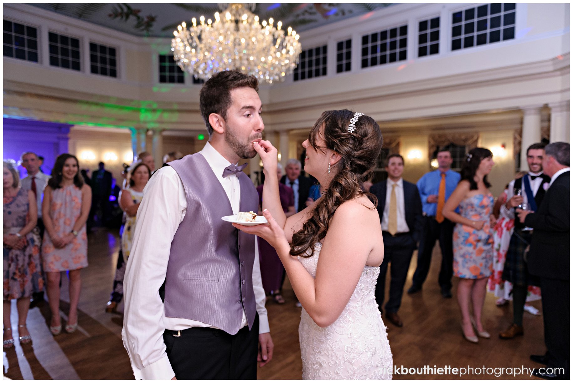 bride feeds groom cake