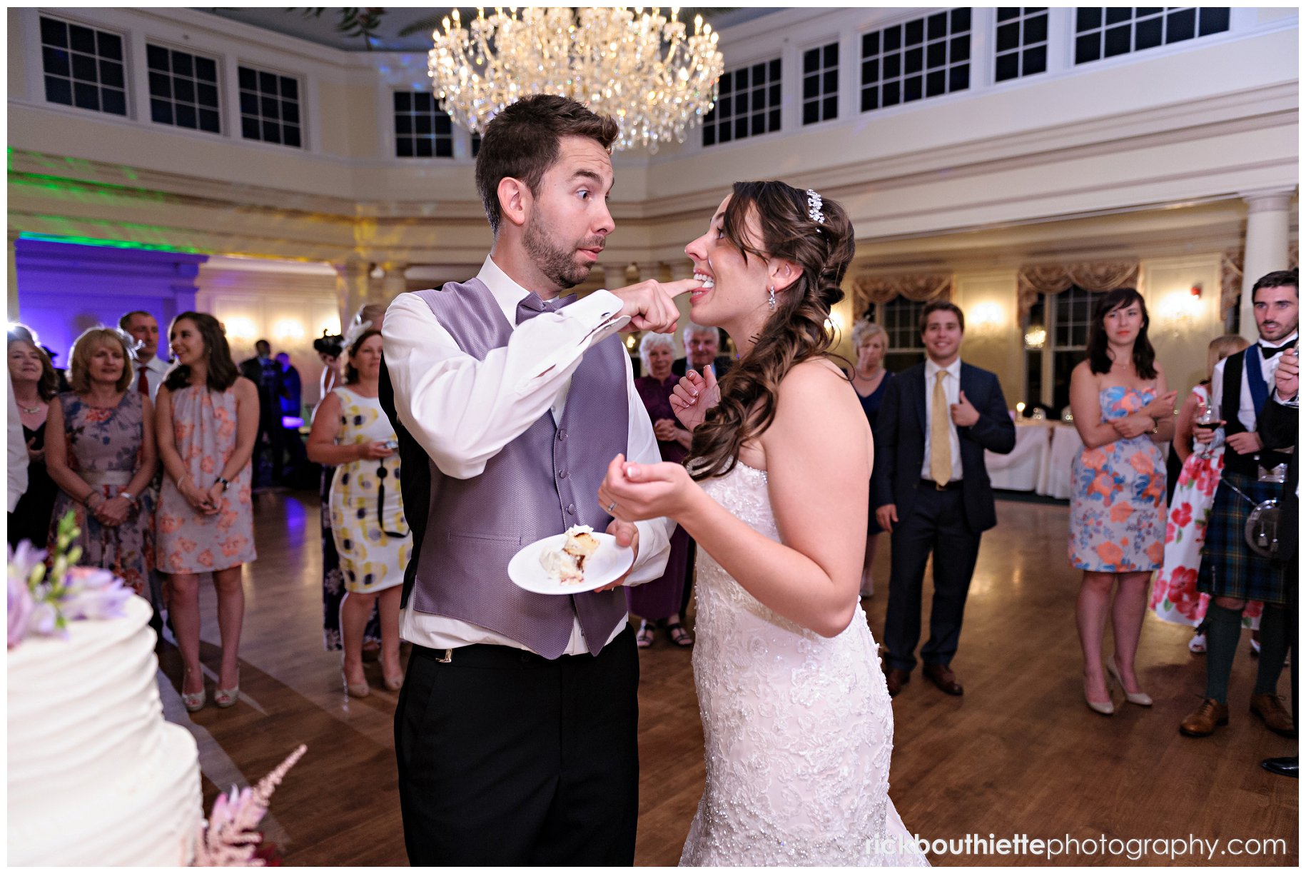 groom feeding bride cake