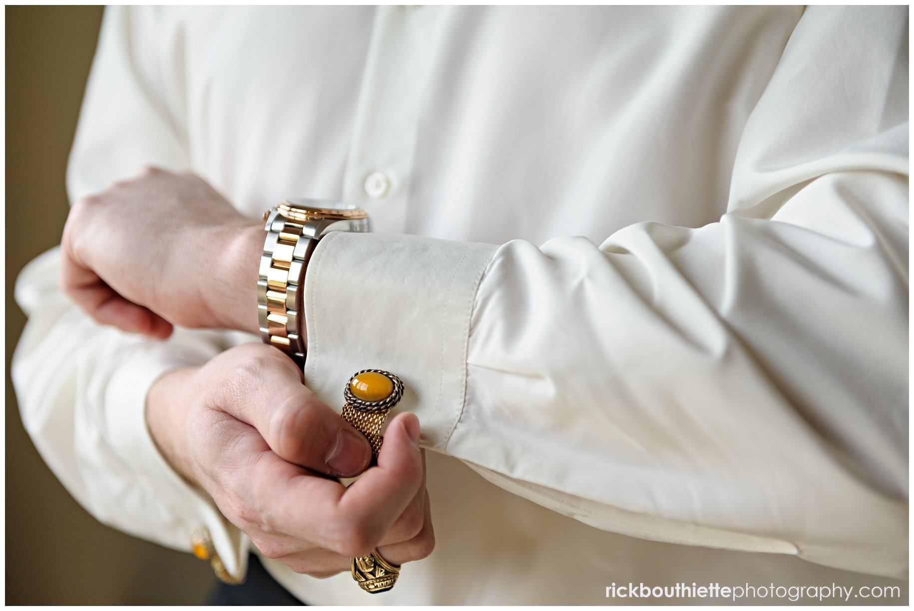 groom shows off his antique cufflinks