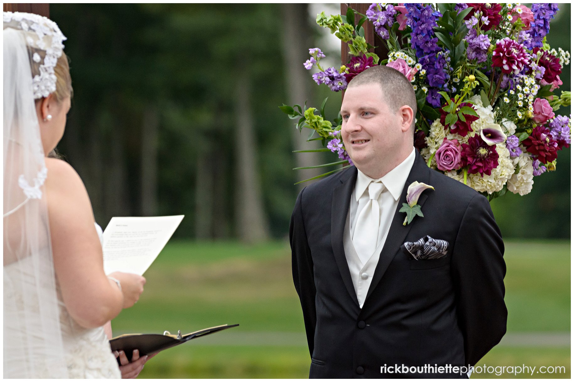 bride reads her vows at wedding ceremony at Atkinson Country Club