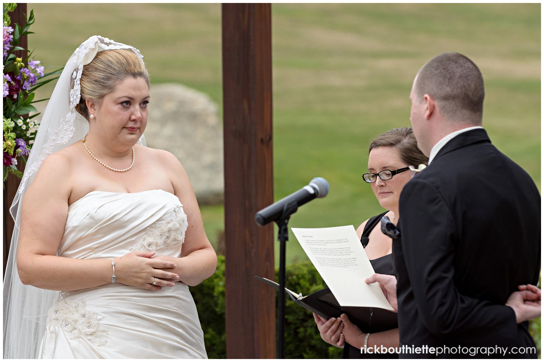 groom reads his vows at wedding ceremony at Atkinson Country Club