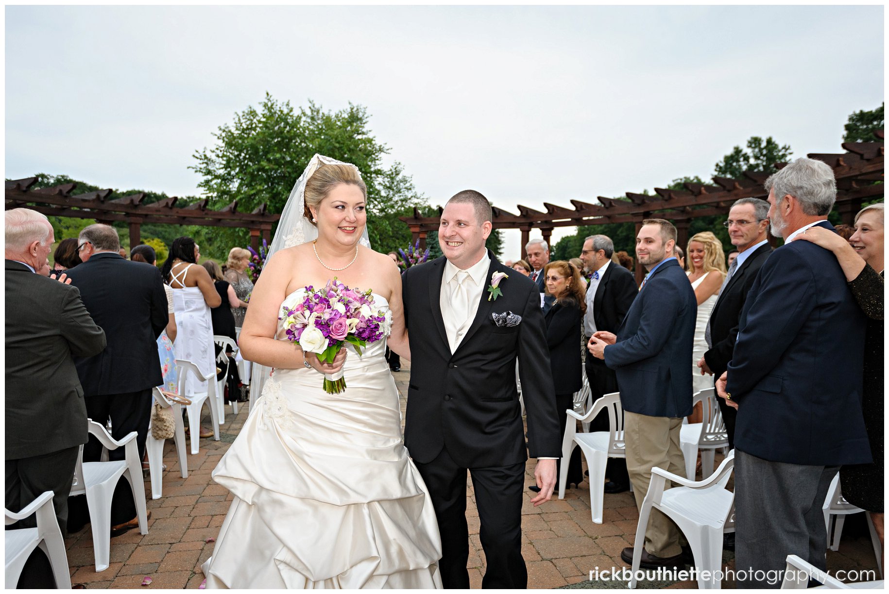 bride and groom walk down aisle at Atkinson Country Club