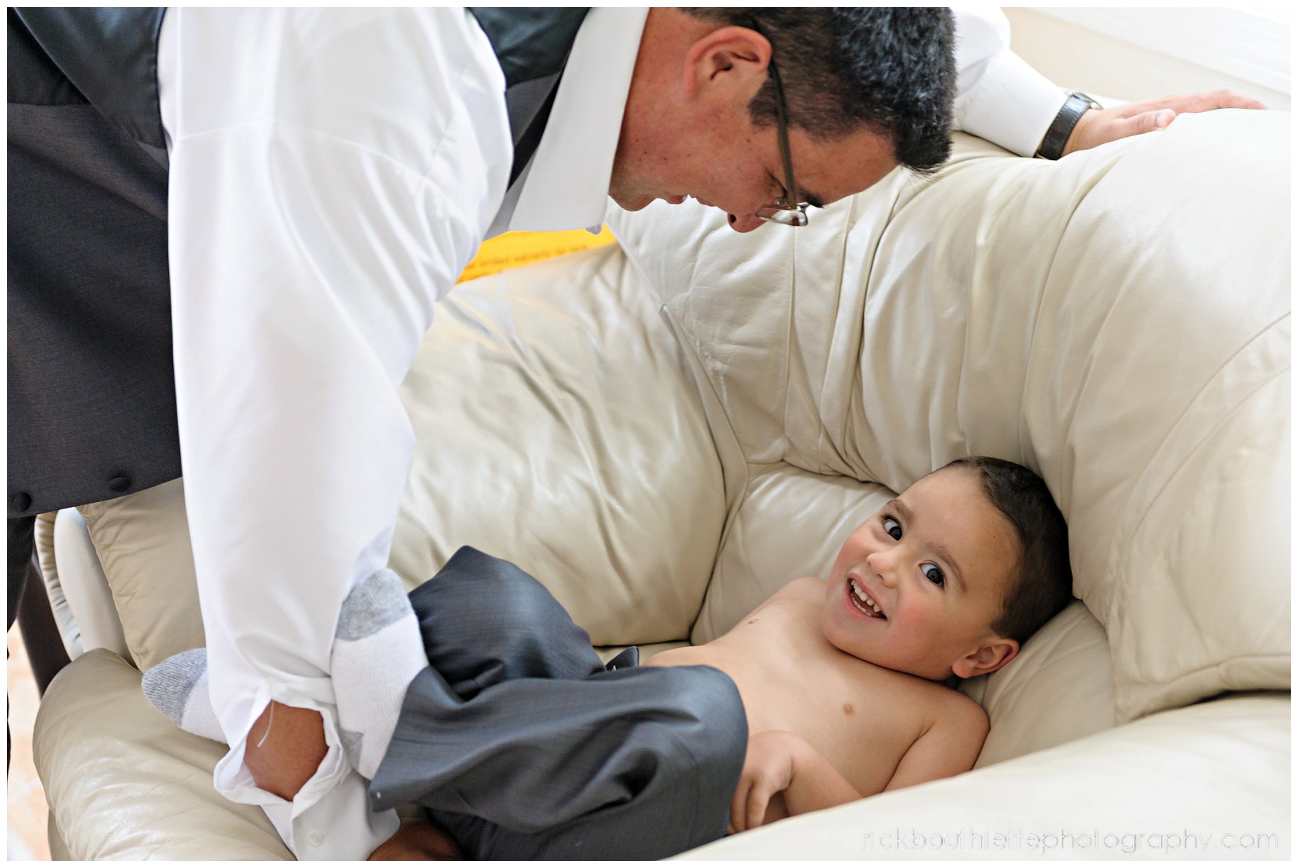 Groom helping his son the ring bearer get ready for his New Hampshire seacoast wedding