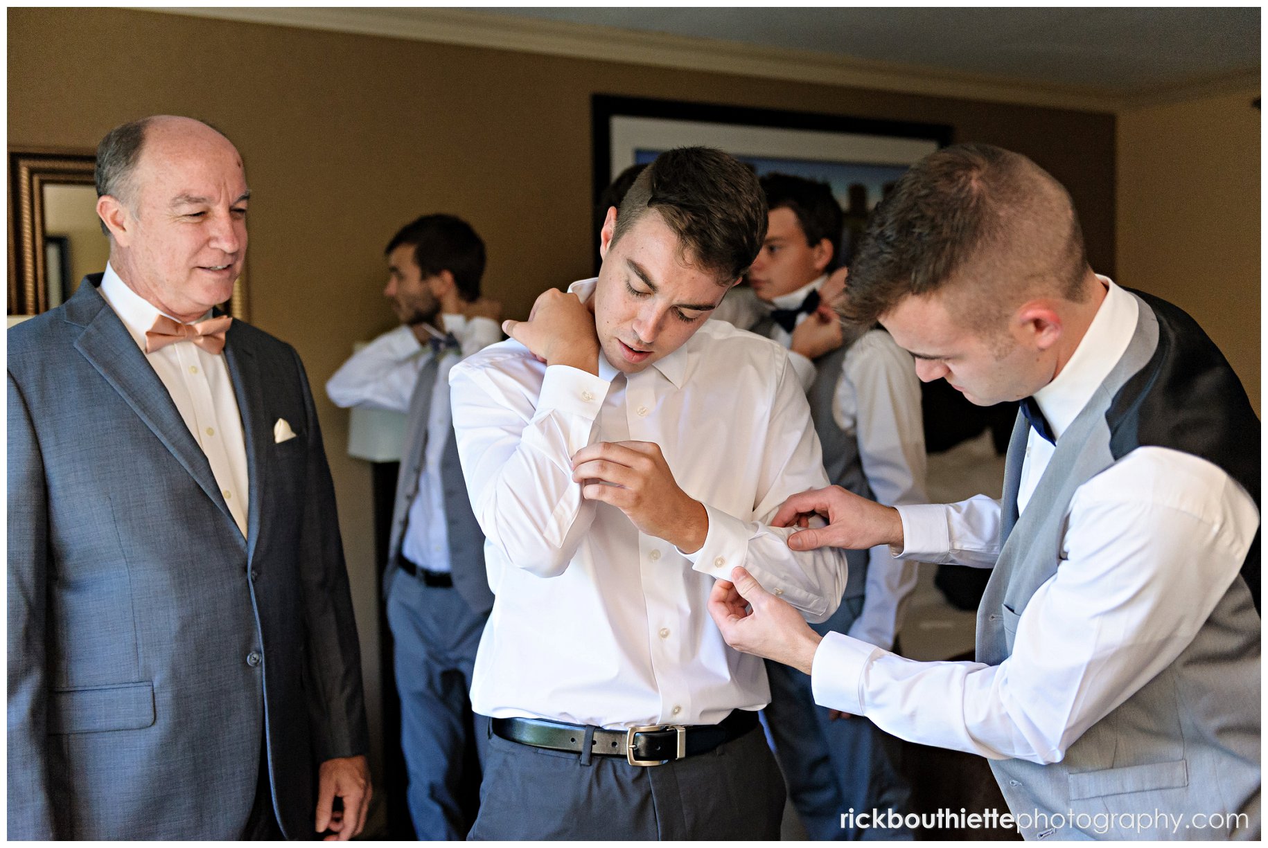 groom getting ready for wedding, adjusting cufflinks