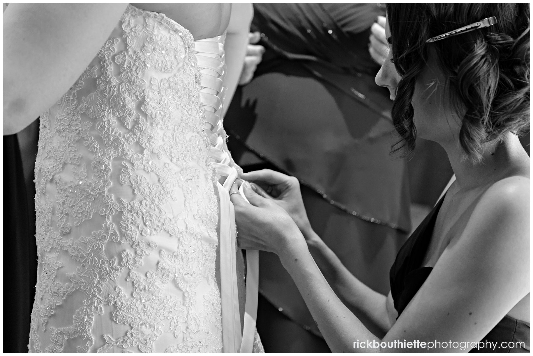 maid of honor lacing bride's dress at Tewksbury Country Club wedding