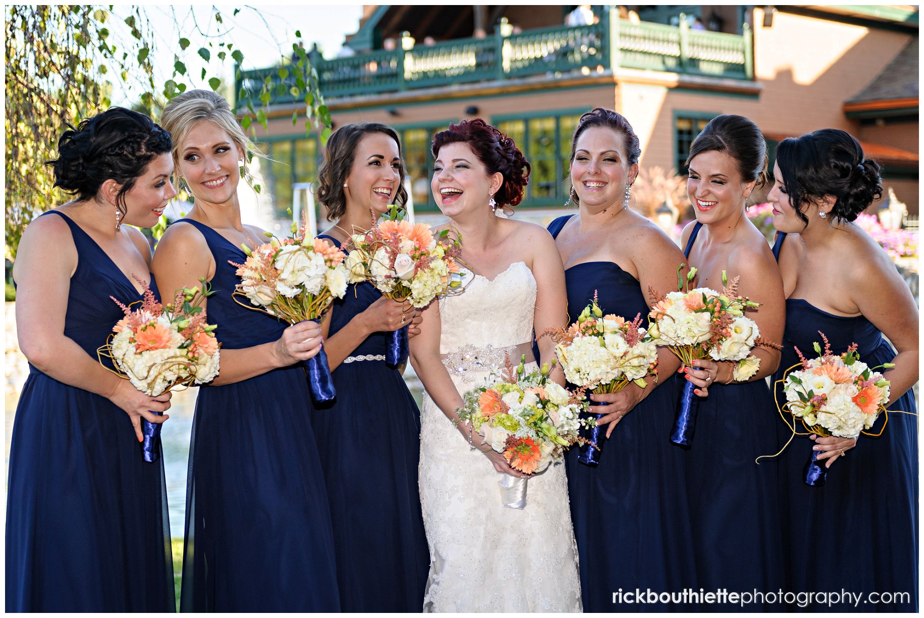 bride and her bridesmaids have a fun moment at Tewksbury Country Club wedding