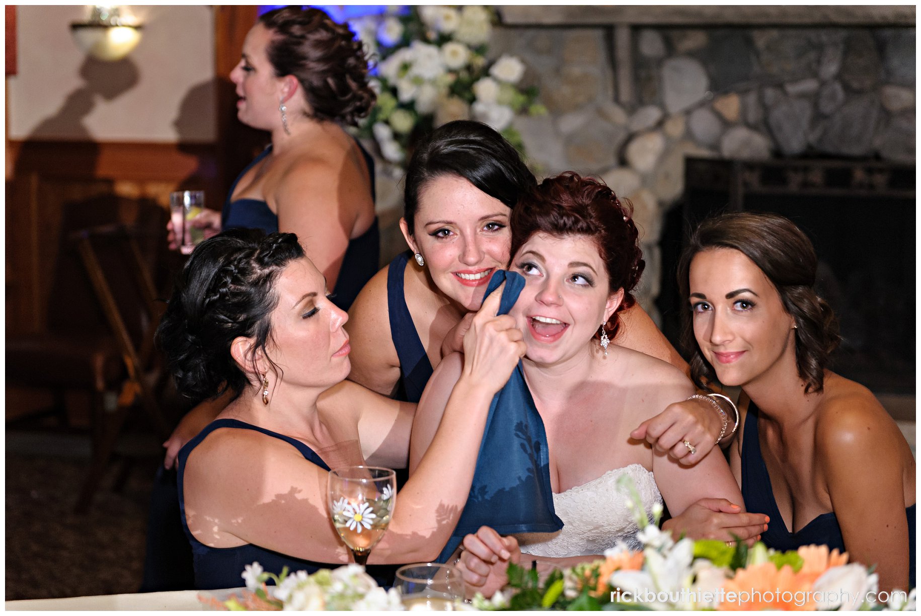 bride surrounded by bridesmaids as she watches the Mother son dance