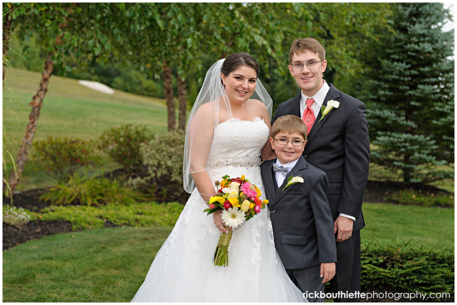 bride & groom with their young son at atkinson country club wedding