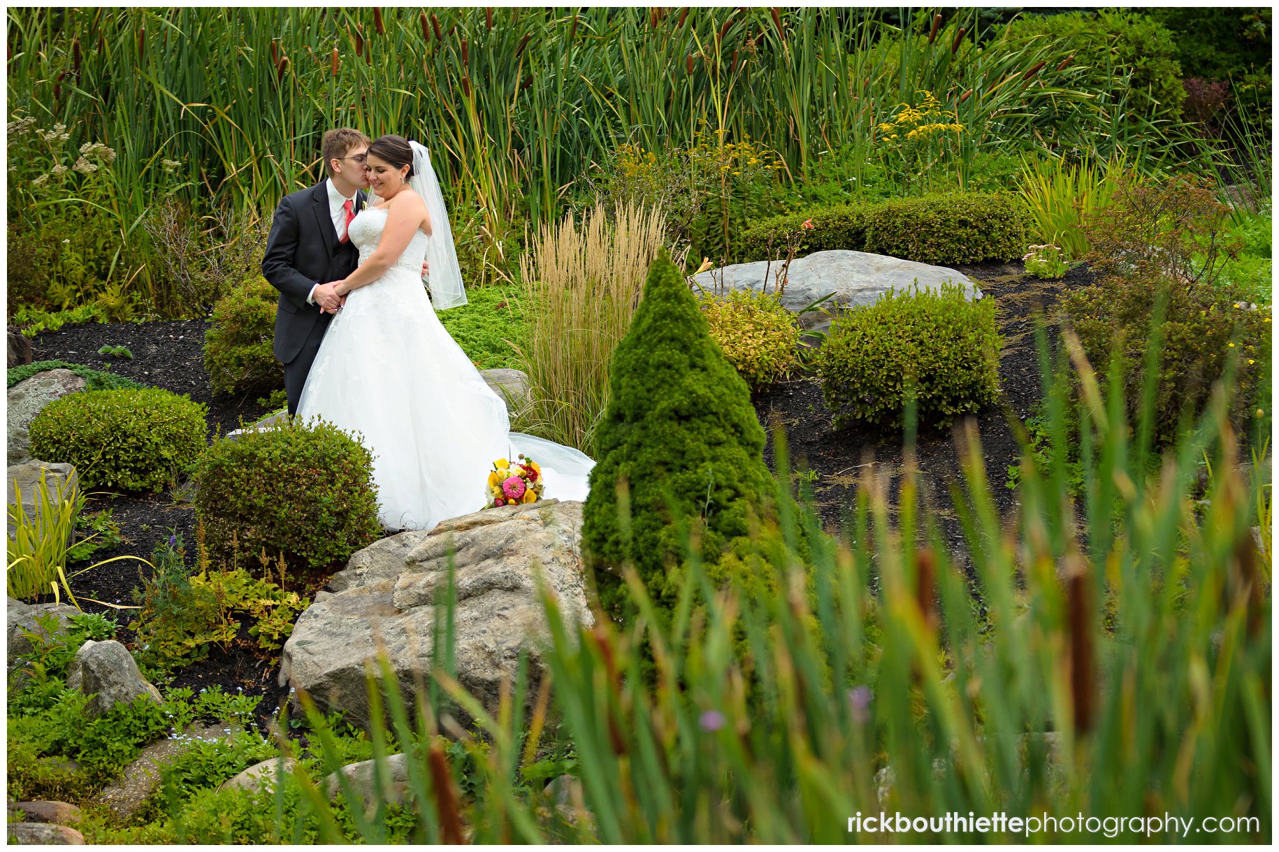 wedding portrait near waterfall at atkinson country club