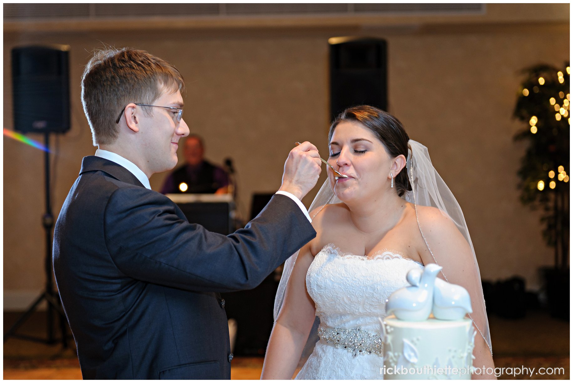 groom feeding the bride cake at wedding