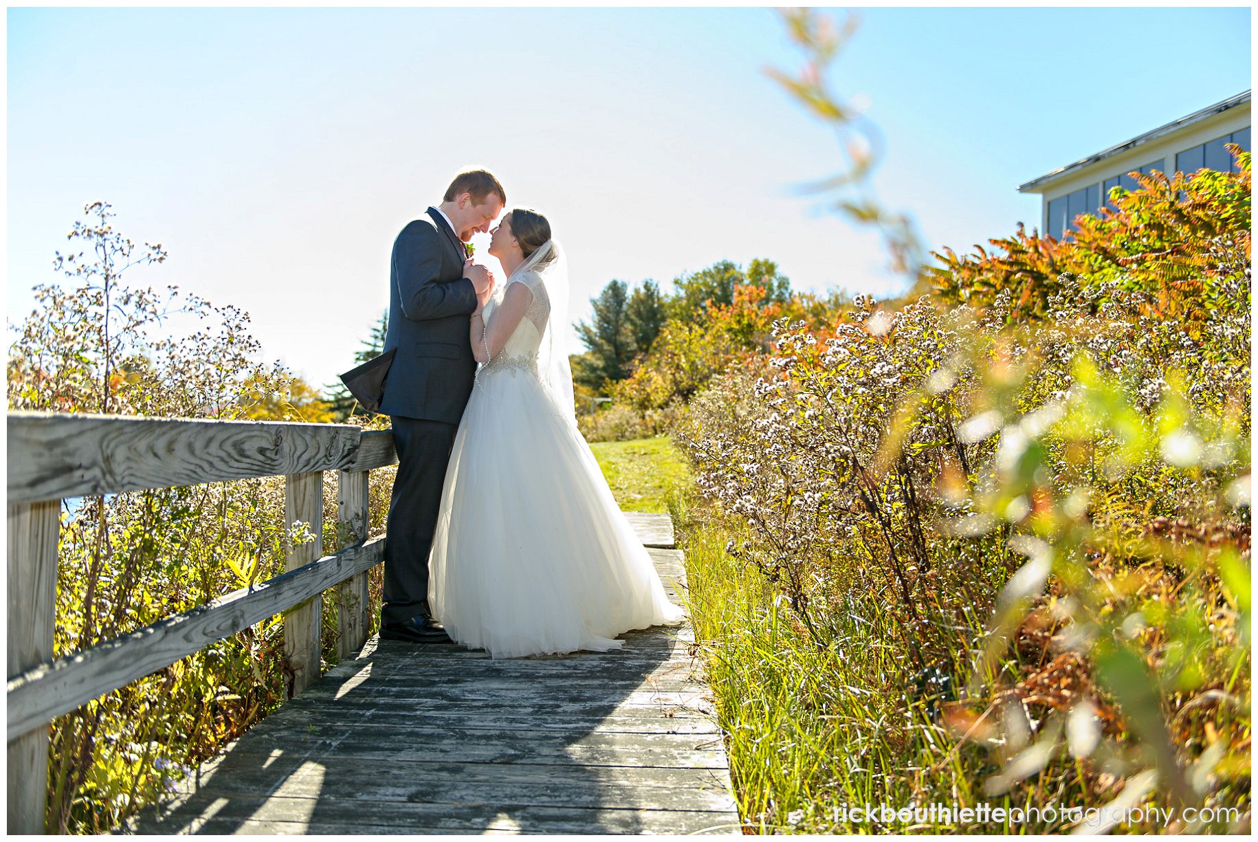 bride and groom on wooden walkway during first look at Indian Head Resort wedding