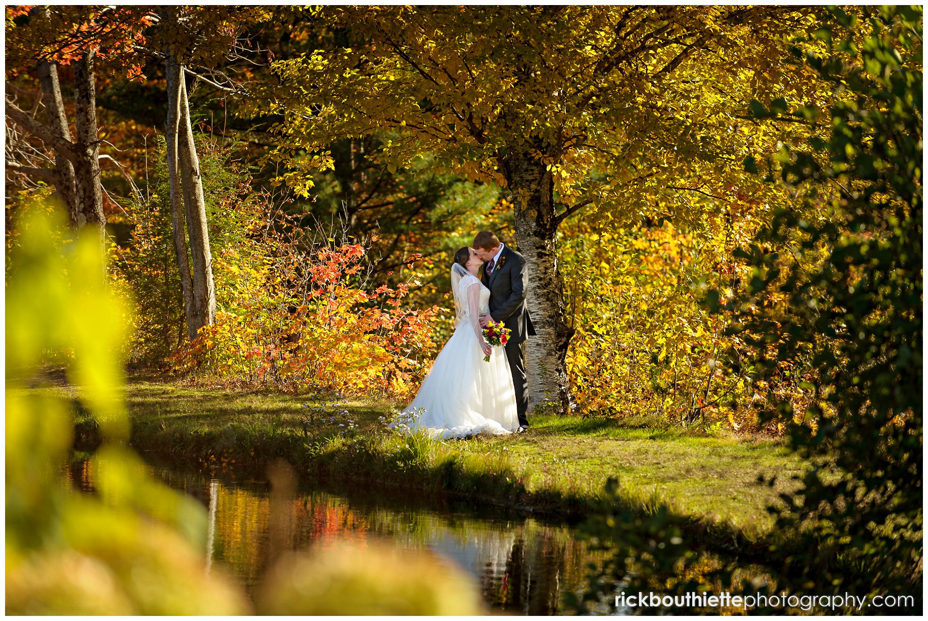bride and groom have a private moment by the lake at Indian Head Resort fall wedding
